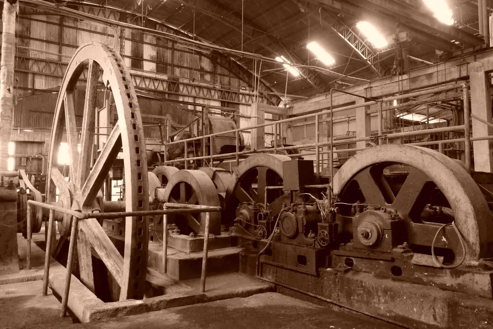 Large flywheels and old machinery inside a former sugar factory, now an arts centre